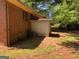 Back exterior view of a brick home with a small addition and exterior AC unit at 6186 Green Acres Sw Dr, Covington, GA 30014