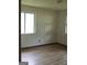 Empty bedroom with new wood floors and neutral walls, showing two windows at 6186 Green Acres Sw Dr, Covington, GA 30014