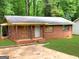 Cozy brick home with a small front yard and covered porch at 6186 Green Acres Sw Dr, Covington, GA 30014