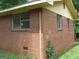 Close up of the side of a brick home with visible window frames at 6186 Green Acres Sw Dr, Covington, GA 30014