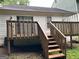 Wooden back deck with stairs and white railing at 1047 Plantation Nw Way, Kennesaw, GA 30144