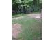 A spacious backyard surrounded by lush greenery and mature trees, offering privacy and shade at 1047 Plantation Nw Way, Kennesaw, GA 30144