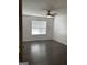 Bright bedroom with ceiling fan, window with blinds, and wood-look flooring at 1047 Plantation Nw Way, Kennesaw, GA 30144