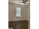 Cozy bedroom featuring modern laminate flooring, a ceiling fan, and a large window at 1047 Plantation Nw Way, Kennesaw, GA 30144