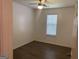 Bright bedroom featuring a ceiling fan, window with blinds, and wood-look flooring at 1047 Plantation Nw Way, Kennesaw, GA 30144