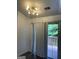 Dining area with sliding glass doors to outdoor patio, modern light fixture, and laminate flooring at 1047 Plantation Nw Way, Kennesaw, GA 30144