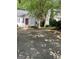 Charming home with a red front door, white siding and a driveway surrounded by mature trees at 1047 Plantation Nw Way, Kennesaw, GA 30144