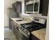 Updated kitchen with stainless steel appliances, granite countertops, and dark wood cabinets at 1047 Plantation Nw Way, Kennesaw, GA 30144