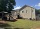 Spacious backyard showcasing a deck, gazebo with hot tub, and well-maintained lawn perfect for outdoor enjoyment at 30 Wellington Trl, Covington, GA 30016