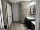 Modern bathroom boasts double sink vanity, decorative wood backsplash, and tiled flooring at 30 Wellington Trl, Covington, GA 30016