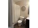 Cozy bathroom featuring toilet with white curtain and patterned backsplash at 30 Wellington Trl, Covington, GA 30016
