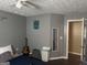 Bedroom with dark floors, a ceiling fan, and a window for natural light at 30 Wellington Trl, Covington, GA 30016