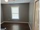 Bedroom featuring dark hardwood floors, neutral walls, and natural light at 30 Wellington Trl, Covington, GA 30016