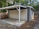 Covered carport with garage door providing secure parking and protection from the elements at 30 Wellington Trl, Covington, GA 30016