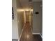 Long hallway with dark hardwood floors and neutral walls that lead to various rooms at 30 Wellington Trl, Covington, GA 30016