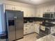 Well-lit kitchen with light-colored cabinets, stainless steel appliances, and ample counter space at 30 Wellington Trl, Covington, GA 30016