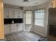 Bright kitchen eating area featuring modern light cabinets, stainless appliances and large windows at 30 Wellington Trl, Covington, GA 30016