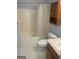 Standard bathroom featuring a shower-tub combo, toilet, and oak vanity cabinet for essential storage at 625 Locust Rd, Locust Grove, GA 30248