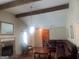 Cozy living room with hardwood floors, exposed beams, and a classic stone fireplace at 625 Locust Rd, Locust Grove, GA 30248