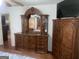 Spacious main bedroom featuring elegant wooden furniture set, including a dresser and wardrobe at 625 Locust Rd, Locust Grove, GA 30248