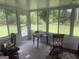 Bright sunroom with multiple windows offering views of the backyard at 625 Locust Rd, Locust Grove, GA 30248