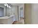 Bathroom featuring white vanity, sink, and bright lighting over mirror at 11616 Spring Lake Way, Fayetteville, GA 30215