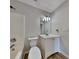 Bathroom featuring wood floors, a modern vanity, toilet, and a shower-tub combo at 11616 Spring Lake Way, Fayetteville, GA 30215
