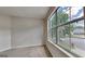 Bedroom featuring carpet and a large window with view of a tree and house at 11616 Spring Lake Way, Fayetteville, GA 30215