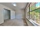 Bedroom featuring light carpet, a closet, and a window with a yard view at 11616 Spring Lake Way, Fayetteville, GA 30215