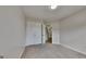 Neutral bedroom with light carpet, double closet, and an open doorway at 11616 Spring Lake Way, Fayetteville, GA 30215