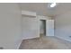 Neutral bedroom with light carpet, an open doorway, and carpeted closet at 11616 Spring Lake Way, Fayetteville, GA 30215