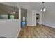 Open-concept dining room with modern lighting and hardwood floors next to kitchen at 11616 Spring Lake Way, Fayetteville, GA 30215