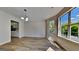 Dining room with wood-look floors and large windows providing natural light at 11616 Spring Lake Way, Fayetteville, GA 30215
