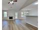 Open-concept living room with a fireplace, wood flooring, and natural light at 11616 Spring Lake Way, Fayetteville, GA 30215