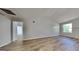 Bright living room featuring vaulted ceilings, wood-look flooring, and a large window at 11616 Spring Lake Way, Fayetteville, GA 30215