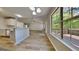 Open living space with view to kitchen, with view of the deck through a large window at 11616 Spring Lake Way, Fayetteville, GA 30215