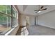 Spacious main bedroom featuring large windows, a ceiling fan, and ensuite bathroom at 11616 Spring Lake Way, Fayetteville, GA 30215