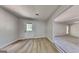 Open room with light-colored flooring and access to the exterior, providing ample light at 11616 Spring Lake Way, Fayetteville, GA 30215