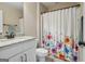 Bright bathroom featuring a floral shower curtain and granite vanity top at 2076 Towne Mill Ave, Canton, GA 30114