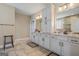 Bathroom with double sink vanity, white cabinets, granite countertops, and neutral tile flooring at 2076 Towne Mill Ave, Canton, GA 30114