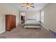 Bedroom featuring ceiling fan, dresser, bed, and walk-in closet at 2076 Towne Mill Ave, Canton, GA 30114
