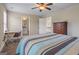 Bedroom features a ceiling fan, ensuite bath, desk, and a large wooden dresser at 2076 Towne Mill Ave, Canton, GA 30114