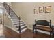 Inviting foyer with hardwood floors, a staircase, and a bench at 2076 Towne Mill Ave, Canton, GA 30114