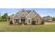 Charming single-Gathering home featuring stone accents, a manicured lawn, and a welcoming front porch at 2076 Towne Mill Ave, Canton, GA 30114
