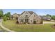 Charming single-Gathering home featuring stone accents, a manicured lawn, and a welcoming front porch at 2076 Towne Mill Ave, Canton, GA 30114