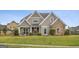 Beautiful home featuring stone accents, a manicured lawn, and a welcoming front porch at 2076 Towne Mill Ave, Canton, GA 30114
