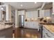 Well-lit kitchen with stainless steel appliances, granite countertops, and white cabinets at 2076 Towne Mill Ave, Canton, GA 30114