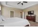 Bright main bedroom featuring tray ceiling, neutral walls, and dark wood dresser with a TV at 2076 Towne Mill Ave, Canton, GA 30114