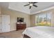 Light-filled main bedroom with neutral carpet, dark wood trim, and a flat screen TV at 2076 Towne Mill Ave, Canton, GA 30114