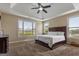 Spacious main bedroom with a large window, plush carpet, and a tray ceiling at 2076 Towne Mill Ave, Canton, GA 30114